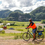 Man Cycling Through Cuban Countryside