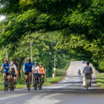 Group of Travellers Cycling Through Cuba