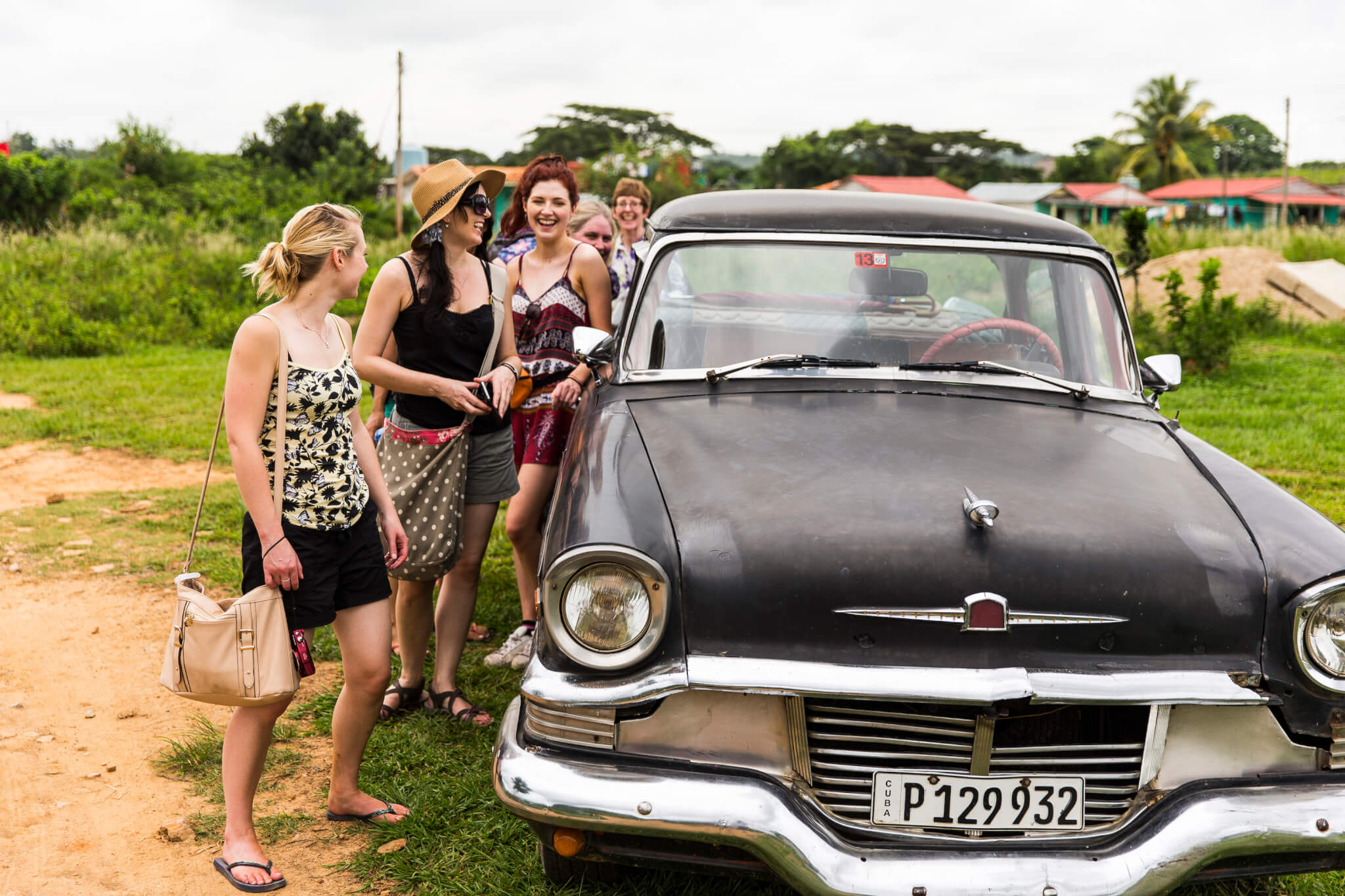Group of Young Women by a Classic American Car in Viñales, Cuba