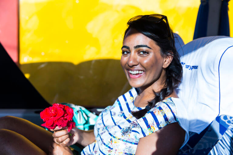 Young Girl Smiling and Holding a Flower in Havana, Cuba