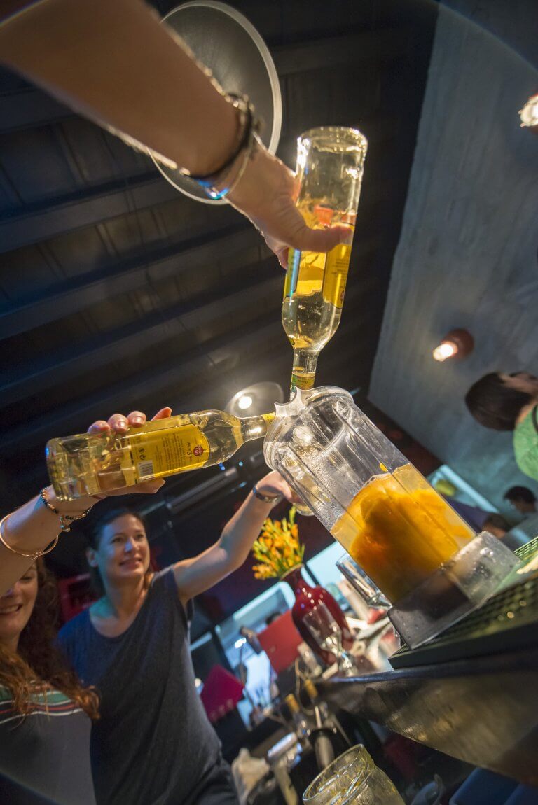 Travellers Mixing Cocktails in a Bar in Havana, Cuba